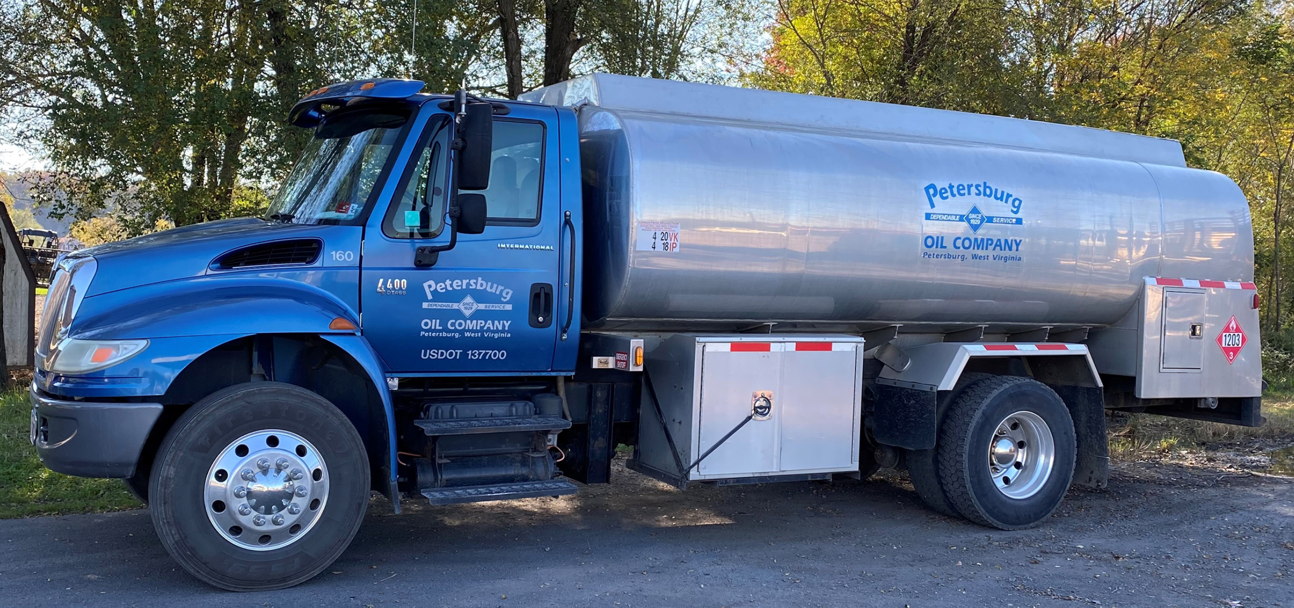 Side view of a Petersburg Oil Company fuel delivery tanker truck for home heating oil and commercial diesel delivery. - petersburgoil.com