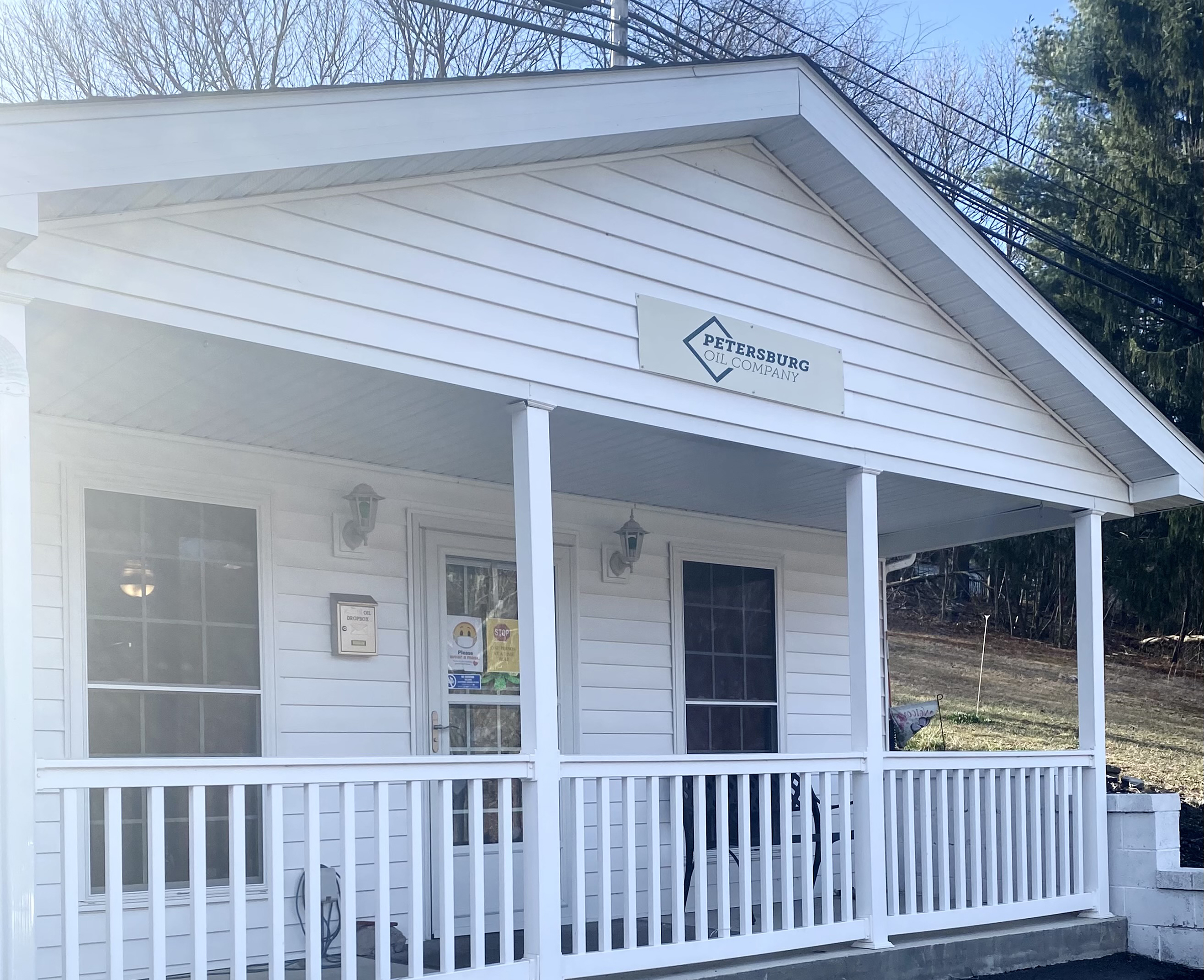 Petersburg Oil Company Office Entrance in Romney West Virginia Front porch and entrance of the Petersburg Oil Company office with white siding in Romney West Virginia -petersburgoil.com
