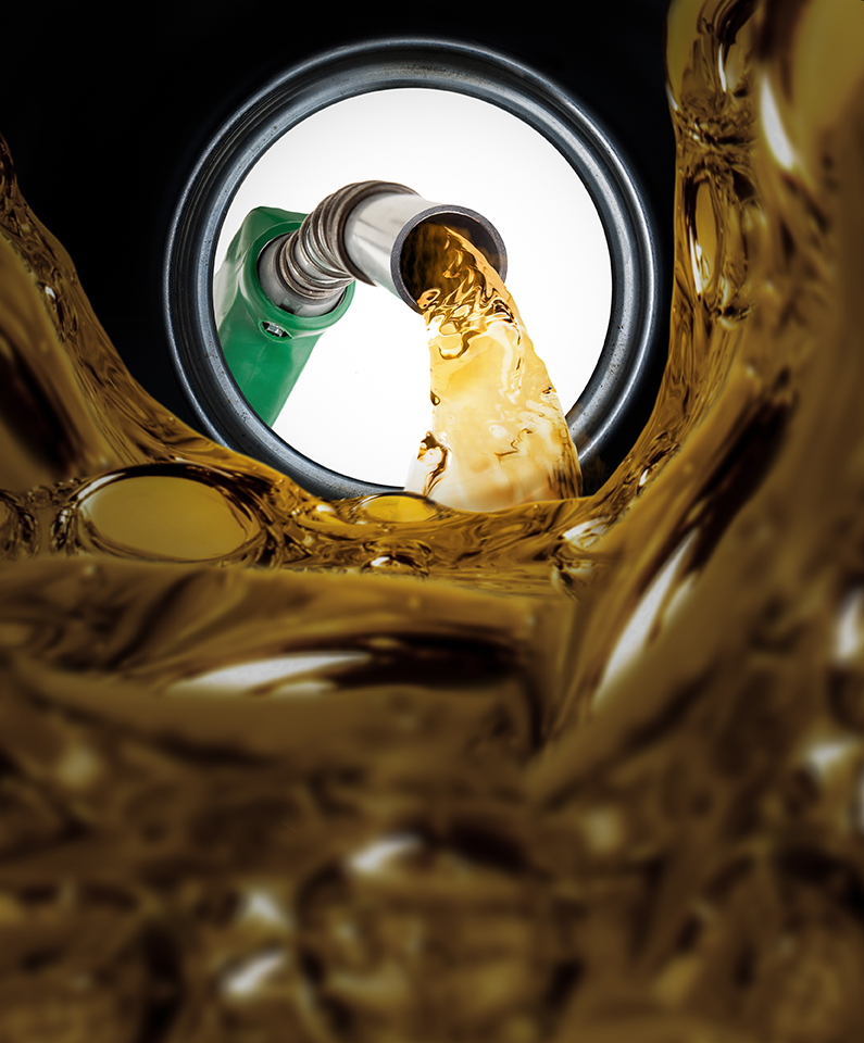 Fuel nozzle pouring gasoline into a vehicle tank viewed from inside -petersburgoil.com<br />
